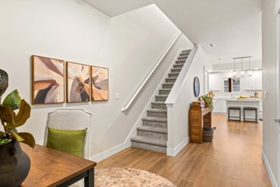 The entry and stairs, kitchen beyond