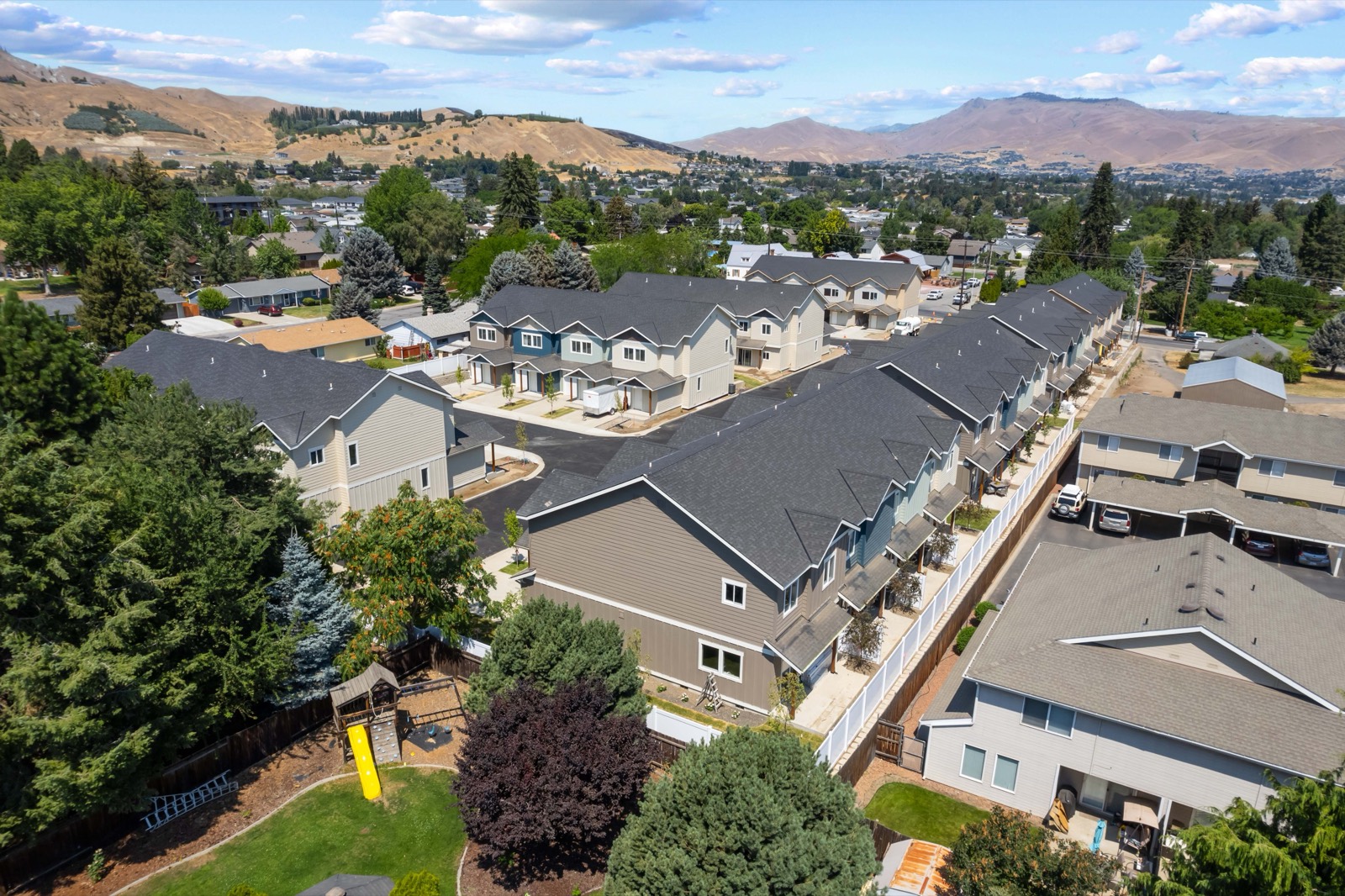 Aerial view of Springwater Townhomes on the Wenatchee benchland with the valley and mountains beyond