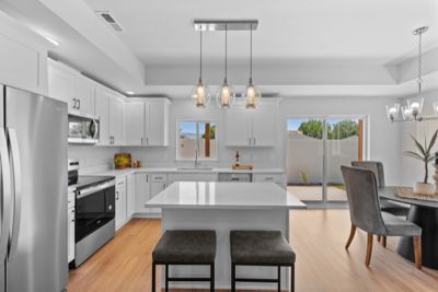 Kitchen with island seating, dining beyond