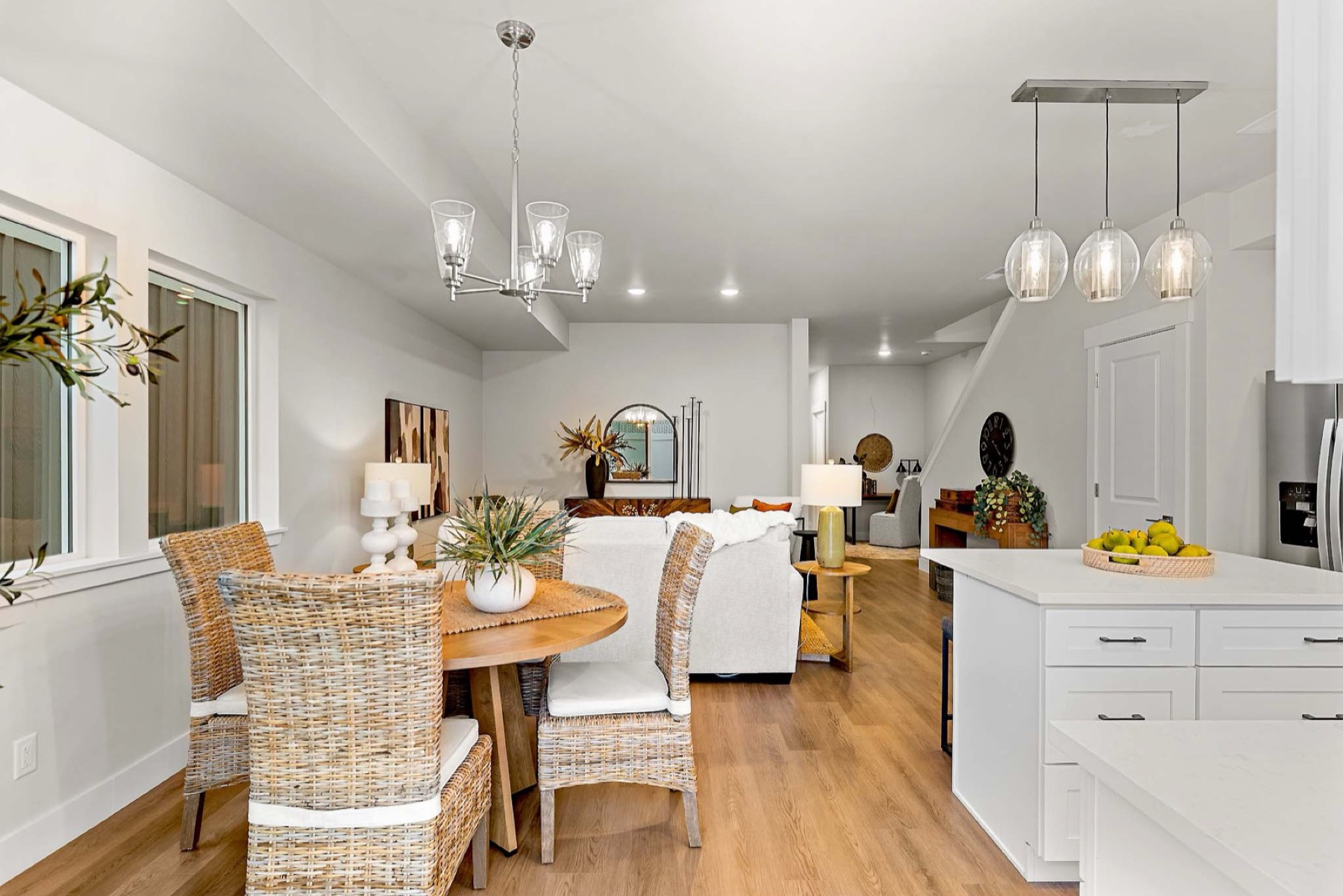 Red Apple model home — living and dining area with staircase (staged; finishes may vary by unit)